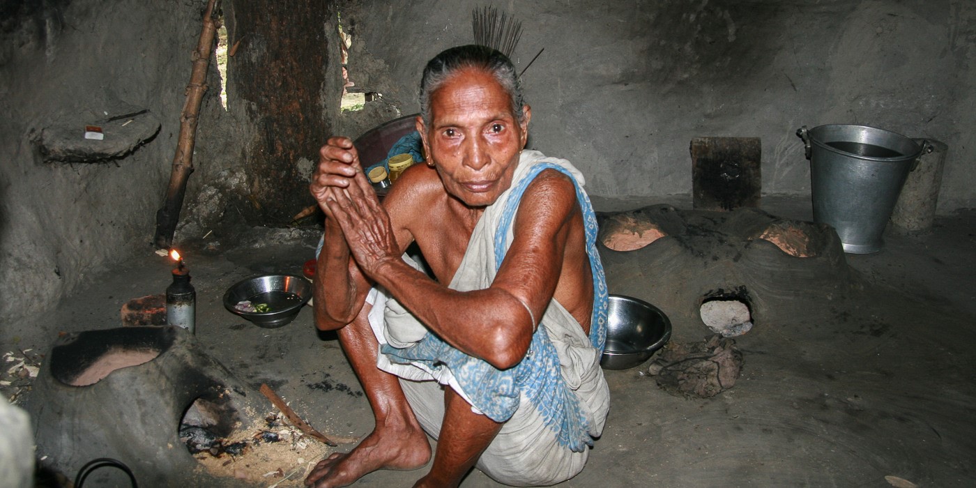 Man Cooking A Dark Room In Cambodia
