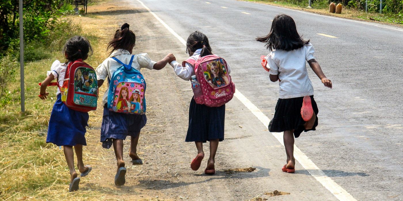 School Girls Running On A Road In Cambodia