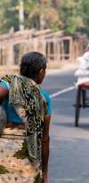 Women Carrying Water In A Jar, Walking On A Street In Cambodia