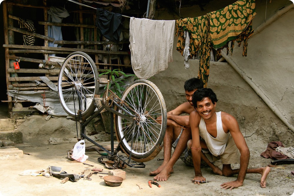 A social enterprise: a disabled man repairing a bicycle in Cambodia